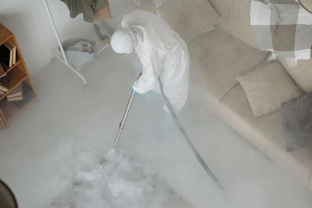 Biohazard cleanup technician in protective equipment, Lewiston, ME